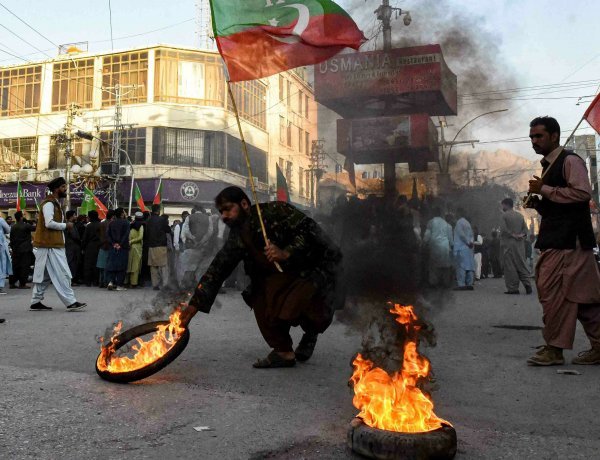 PTI supporters protest before the start of the long march: raided the home minister's house