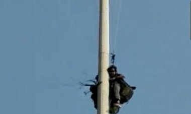 Paragliding woman and trainer trapped in electric pole